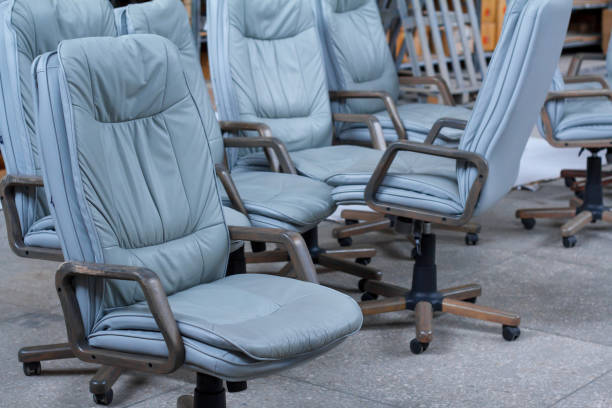 Several gray leather office chairs ready for packaging in a furniture warehouse, online furniture store.